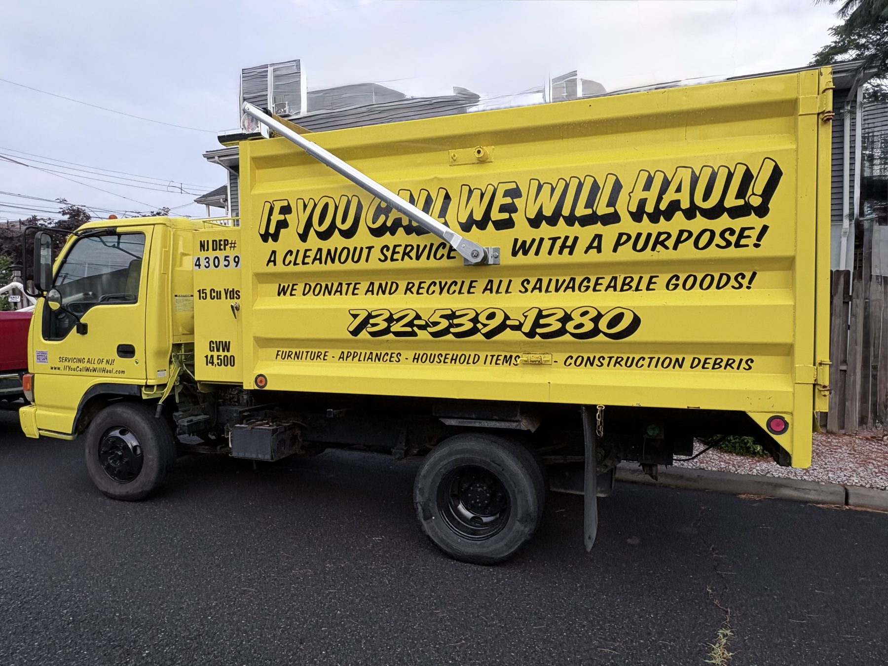 If You Call We Will Haul dump truck loaded and ready to haul junk